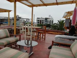 a patio with chairs and a table on a roof at Garden House Miraflores in Lima