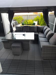 a couch sitting under a canopy on a patio at Liverpool Air b and b in Sefton