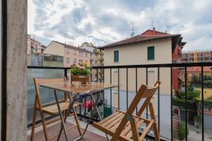 a balcony with a table and chairs on a balcony at [Luxury apartment near Navigli] Carlo D'adda 29 in Milan
