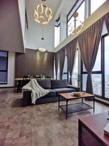 a living room with a couch and a table at Expressionz Professional Suites by AURORA SUMMER SUITES in Kuala Lumpur +68 photos