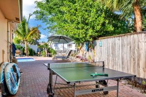 a ping pong table in front of a fence at Purely Pompano, Pool, Water front, Paddleboard, Beach, 5 bedroom 3 bath in Pompano Beach