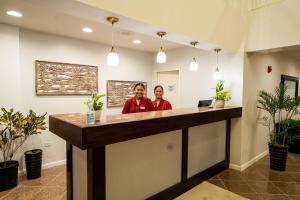 two people standing at a counter in a lobby at Paradiso Resort & Spa in Saipan