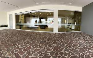 a large room with a carpeted floor and a lobby at Hotel Refugio in San Juan de los Lagos