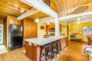 a kitchen with wooden cabinets and a black refrigerator at Peak-a-View Lakehouse in Ronald