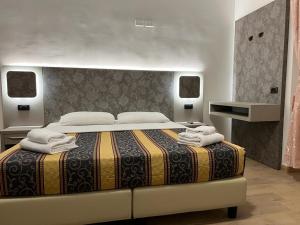 um quarto com uma cama grande e toalhas em Hotel principe em Roma