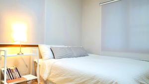 Llit o llits en una habitació de JJ House Gwangan Beach