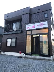 a black building with a sign that reads stay fired at STAY Sakura in Bibai