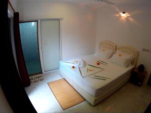 Letto o letti in una camera di Maafushi View
