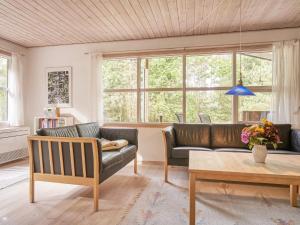 a living room with a couch and a table at Bright Beach Retreat - By Traum Ferienwohnungen in Vester Sømarken