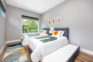Duas camas num quarto com uma janela em #4 Tropical Paradise with Saltwater Heated Pool 10 min to Siesta Key Beach em Sarasota