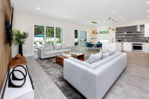 uma sala de estar branca com um sofá e uma mesa em #4 Tropical Paradise with Saltwater Heated Pool 10 min to Siesta Key Beach em Sarasota