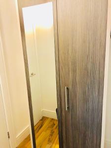 a wooden door in a room with a wooden floor at City Sparrow Nest - 2W in London