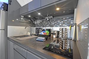 a kitchen with a sink and a counter top at Deja Blue - Comfortable Beachfront condo in Marigot