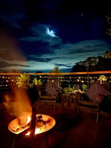 a fire pit on a patio at night at Doomben Ridge Accommodation in Beechmont