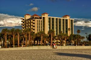a large building with palm trees in front of it at Pier House 60 Clearwater Beach Marina Hotel in Clearwater Beach