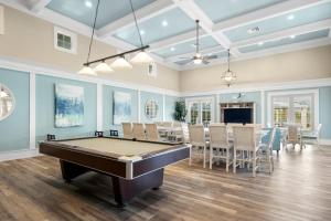 a living room with a pool table and a dining room at 933 Cinnamon Beach, 3 Bedroom, Sleeps 8, 2 Pools, Elevator, WiFi in Palm Coast