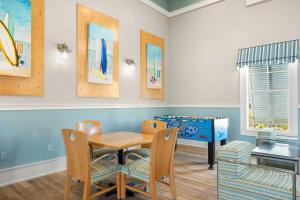 a dining room with a table and chairs and a bed at 933 Cinnamon Beach, 3 Bedroom, Sleeps 8, 2 Pools, Elevator, WiFi in Palm Coast