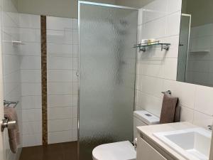 a bathroom with a shower and a toilet and a sink at Edge Of The Forest Motel in Margaret River Town