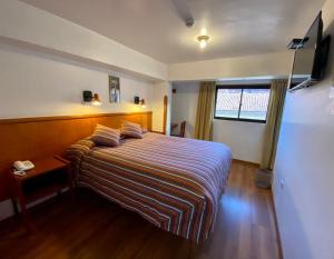 Rúm í herbergi á Saphi Inn Cusco - Excelente ubicación