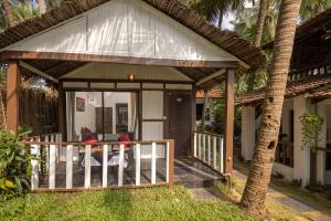 a screened in porch of a house at Forget Me Not Resort in Agonda