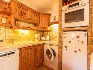 eine Küche mit einem weißen Kühlschrank und einer Waschmaschine in der Unterkunft Charmant 2 pièces à Valmorel avec balcon, linge de lit et ménage inclus, 4 pers. - FR-1-291-879 in Valmorel + 2 Fotos