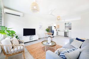 a living room with a couch and a tv at 'Botanica Hermosa' Enjoy the Best of Nightcliff in Nightcliff