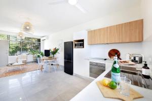 a kitchen with a bottle of wine on a counter at 'Botanica Hermosa' Enjoy the Best of Nightcliff in Nightcliff