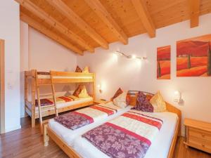 a bedroom with two beds and a bunk bed at Chalet Wasserfall, Krimml in Krimml