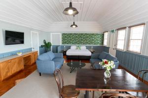 a living room with a couch and a table at The Old Oak Boutique Hotel in Mangonui