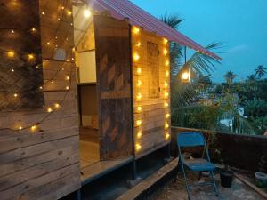 a house with lights on the side of it at Adams Wood House Ayurveda Homestay Kochi in Cochin