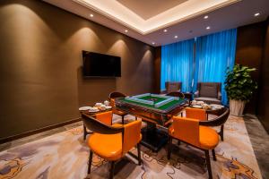 a dining room with a table and a pool table at Howard Johnson by Wyndham Lanting Hotel Ningbo in Ningbo
