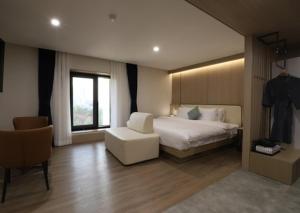 Llit o llits en una habitació de H Avenue Hwamyeong