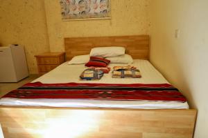 a small bedroom with a bed with two bags on it at Bedouin Garden Village, hotel Dive in Aqaba