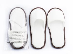 a pair of white shoes with a bag of receipts at APA Hotel Nagasaki Dejima in Nagasaki
