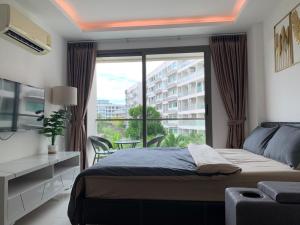 Postel nebo postele na pokoji v ubytování Laguna beach condo resort 3 maldives pattaya pool view ลากูน่า บีช คอนโด รีสอร์ต 3 พัทยา + 37 fotografií