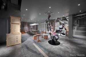 a room with a table and a sculpture in it at KAIKA TOKYO by THE SHARE HOTELS in Tokyo