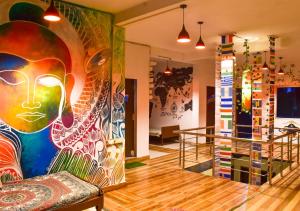 a room with a large painting on the wall at Skyard Hostel Rishikesh Laxman Jhula in Rishīkesh
