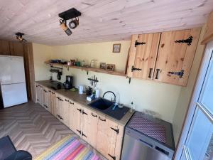 a kitchen with wooden cabinets and a sink at Käspri Farmstay in Koguva