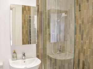 a bathroom with a shower and a sink at Bryn Mor in Benllech +43 photos