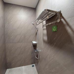 a shower in a bathroom with a shower head at 3 Point Syariah Residence in Jakarta