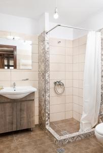 a bathroom with a shower and a sink at Limnaio in Chrysohorafa