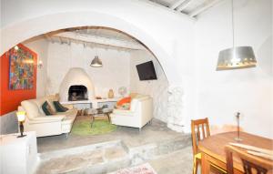 a living room with an archway and a fireplace at Beautiful Home In Villeseque Des Corbier With House A Panoramic View in Villesèque-des-Corbières