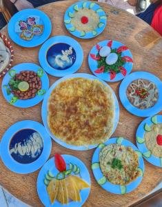 a table with plates of food on it at New Panorama Resort in Fayoum