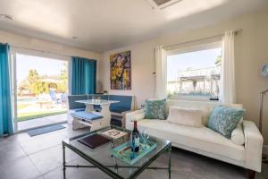 a living room with a couch and a table at MAGIC VILLA Overlooking Pool Oasis in Temecula
