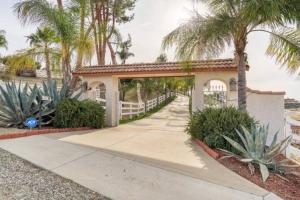 a house with a white fence and palm trees at MAGIC VILLA Overlooking Pool Oasis in Temecula