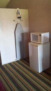 a white refrigerator freezer sitting next to a white wall at Howard Johnson by Wyndham Phoenix Airport/Downtown Area in Phoenix