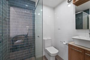 a bathroom with a toilet and a sink at Scamander Beach Resort in Scamander