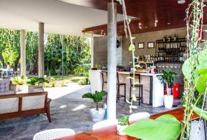 an outdoor kitchen with tables and chairs and plants at Kampot Tropical Village in Kampot