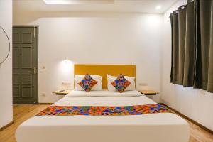 a bedroom with a large bed in a room at FabHotel Roseman in New Delhi