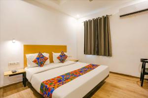 a bedroom with a large bed in a room at FabHotel Roseman in New Delhi
